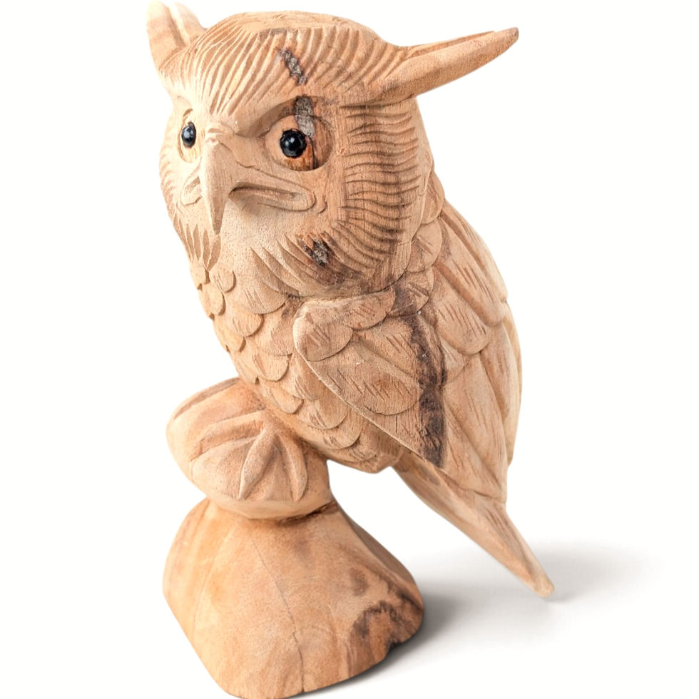 Hand-carved teakwood owl figurine perched on a sculpted wooden branch