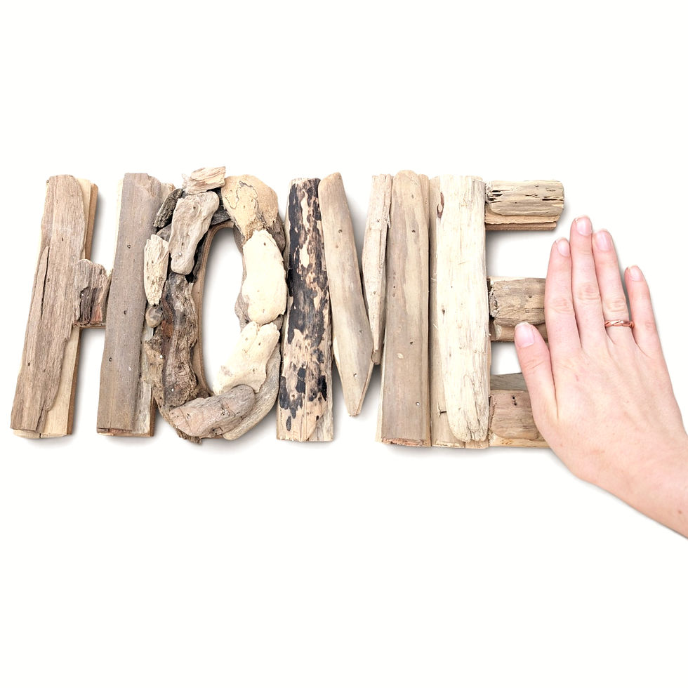 Thumbnail: Found driftwood HOME sign displayed on a light wood surface