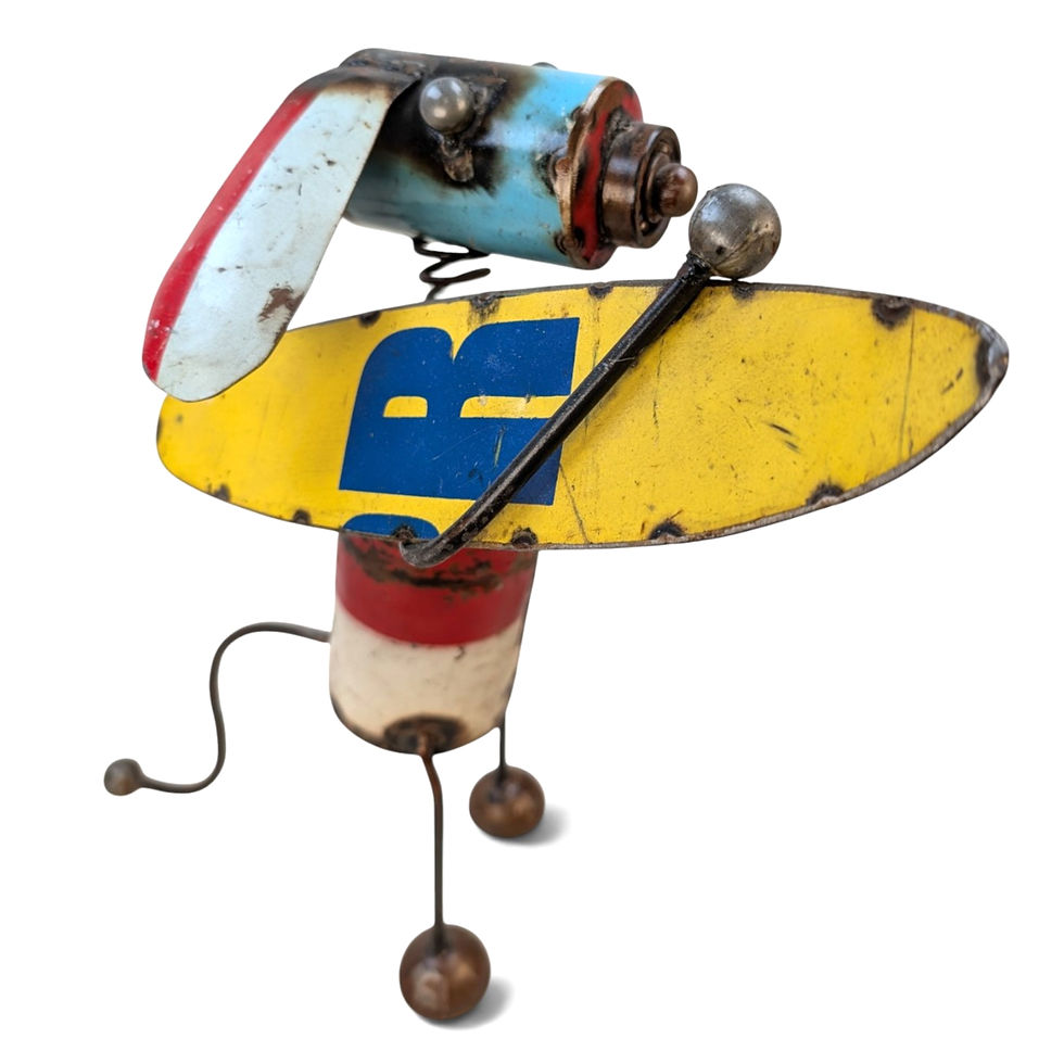 Metal surfer dog figurine carrying a yellow surfboard