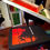 Thumbnail: Colour photograph of the Rockaway Mob long-sleeved t-shirt in black and red being printed i the Carry on Screening studio.