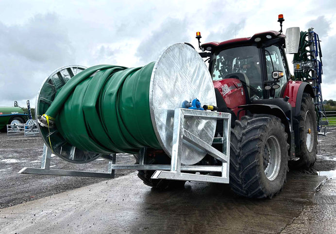 tractor with hose reeler attached to the front of the vehicle.