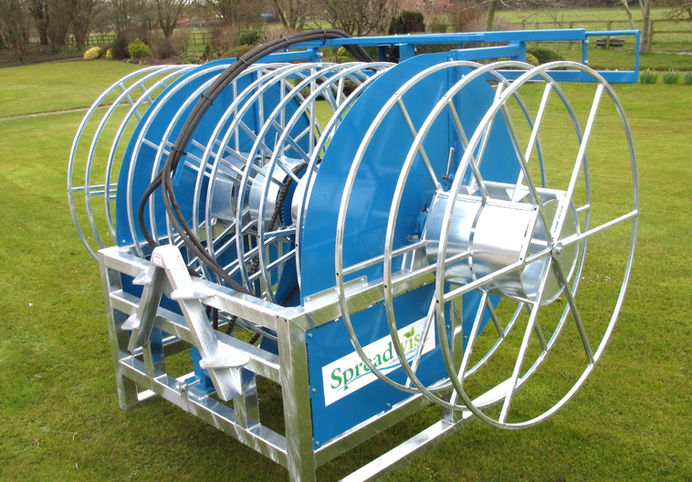 reeler attached to rear of tractor.