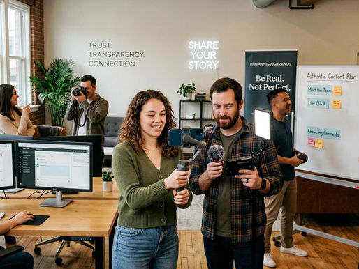 A team in a bright office creates social media content using cameras, lights and smartphones, with wall text and planning boards highlighting trust, transparency, storytelling and community engagement.