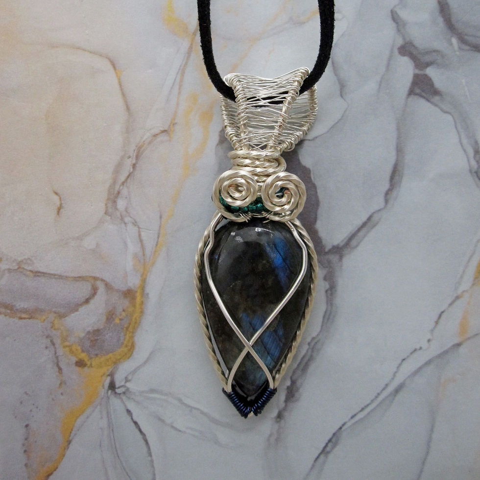 Thumbnail: Labradorite pendant with silver plated twisted wire wrap and seed bead details on leather cord