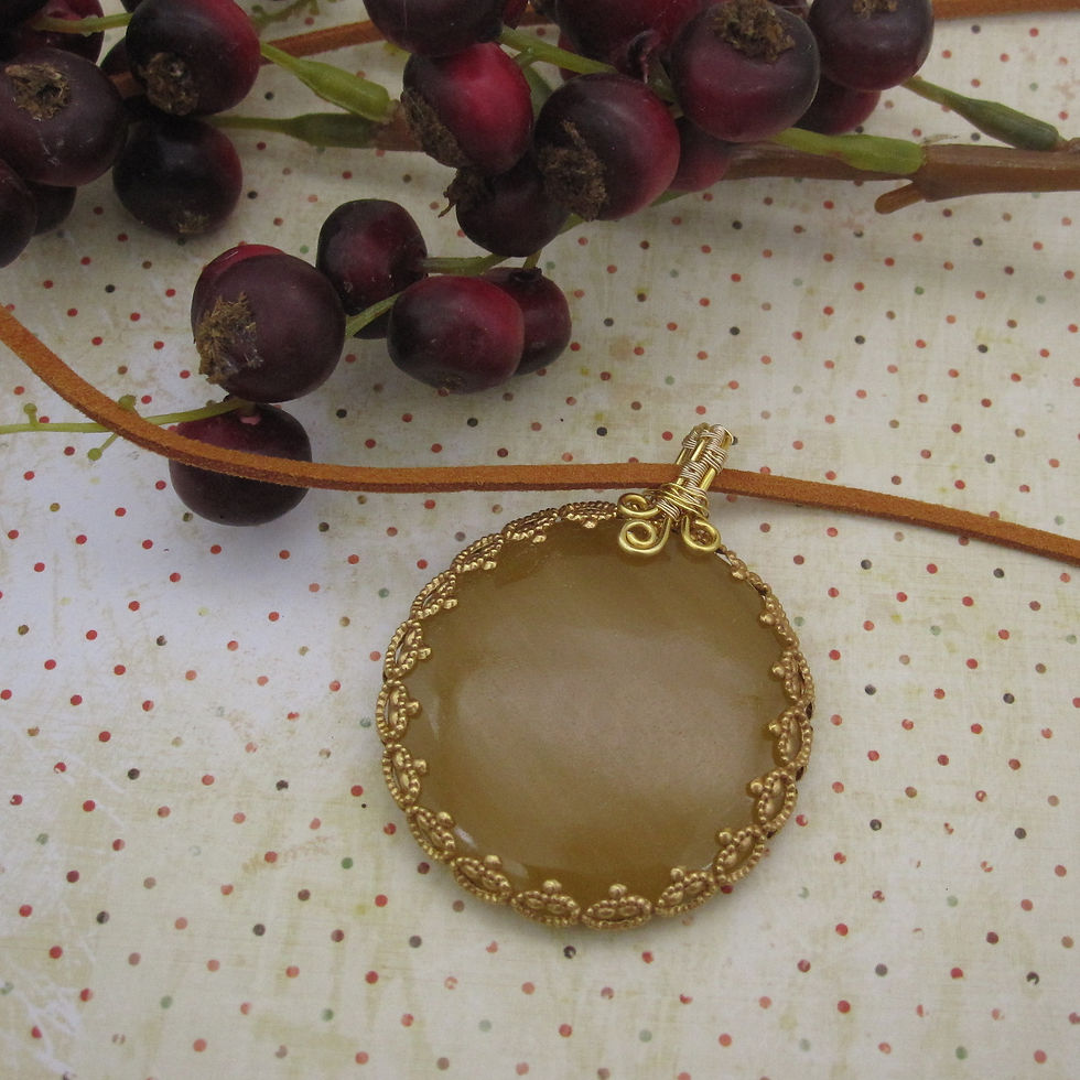 Circular gemstone pendant, bright sunflower yellow with gold coloured wire wrapping. On leather cord.
