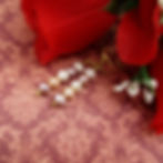 Earrings with a column of 5 pearls in pastel tones from lilac to peach on gold plated ear wires.