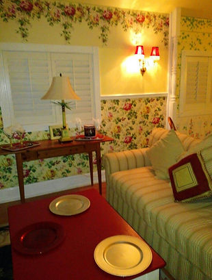 Cottage Sitting area with feather couch, red top coffee table and Ethan Allen pine table.