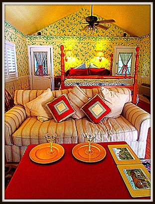 Cottage interior with king bed, cathedral ceilings and feather couch.