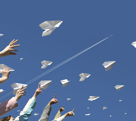 The hands of children throw upwards mess