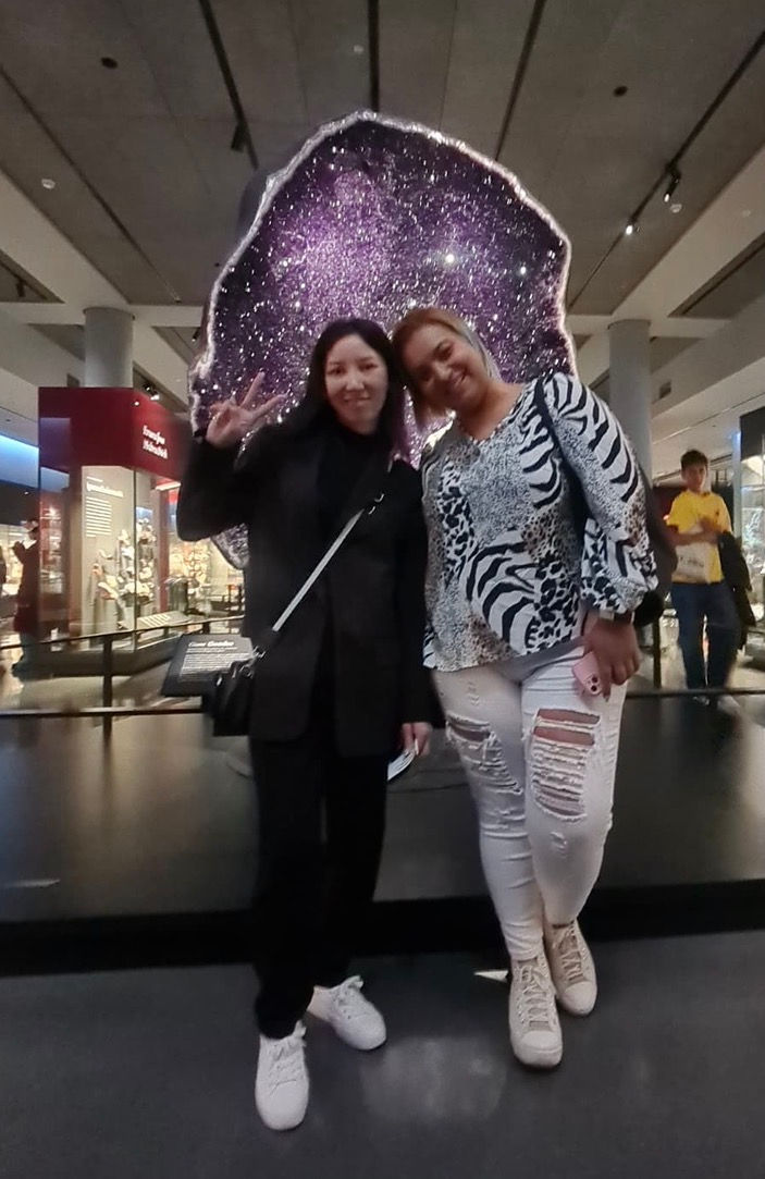 Paula and her student enjoy their field trip to the American Museum of Natural History, posing in front of a stunning amethyst geode.