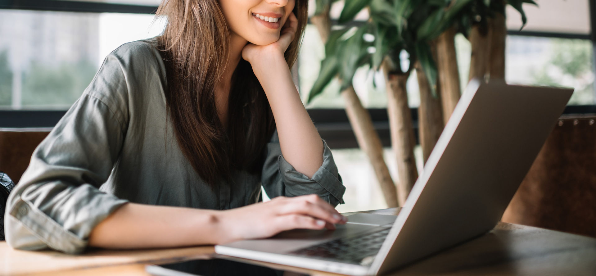 Woman in front of lap top possibly during a virtual womxn trauma group session