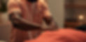 dark skin black male massage therapist massaging a black women .jpg