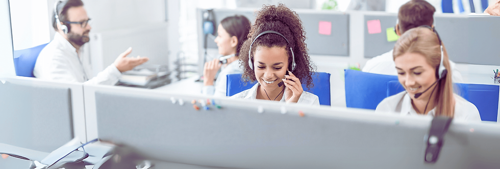 Woman behind desk with headphone set answering telephone