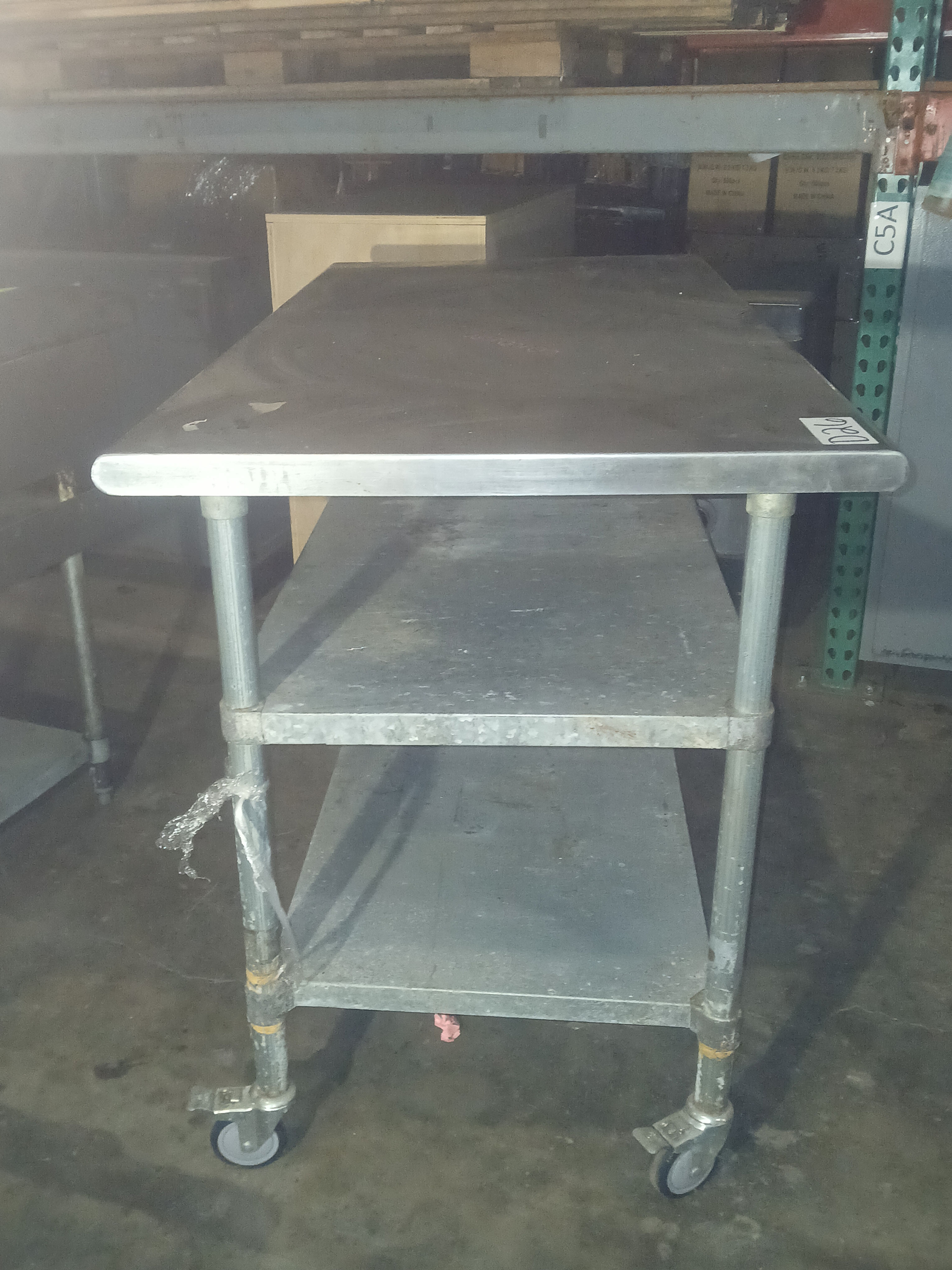 STAINLESS STEEL TABLE ON CASTERS