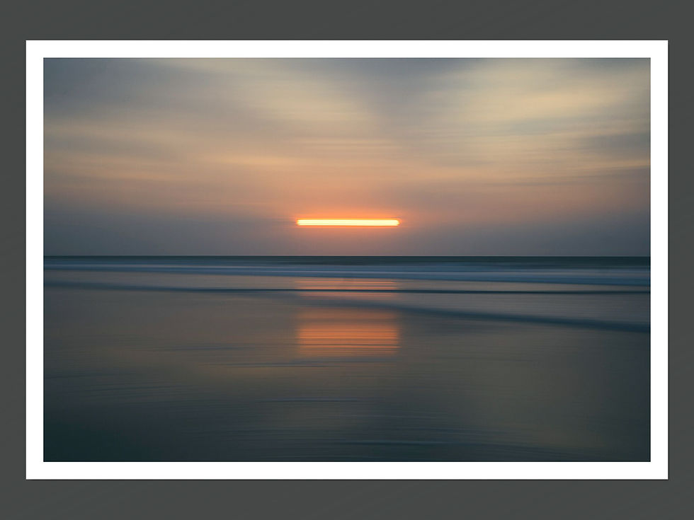 A fine art photograph featuring a sunset or sunrise with a long exposure effect on the shoreline