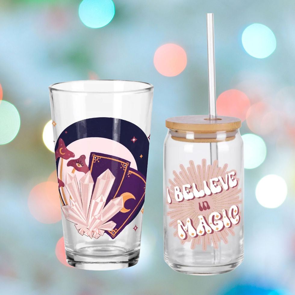 Tall pint glass with esoteric crystals and tarot cards and a glass sipper with lid and glass straw with a retro typography design saying I believe in magic, both by Threadless.