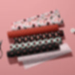 6 bolt of fabric featuring several Japanese sushi themed patterns in a red, pink and black color palette