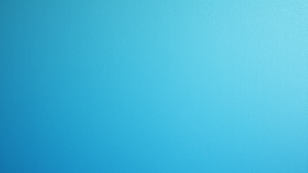 Close-up view of a freshly painted blue exterior wall with clean edges