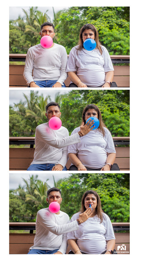Fun maternity gender reveal photoshoot with couple blowing balloons outdoors.
