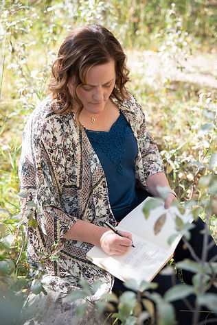 Empowerment coach Kristell Court writing in a journal