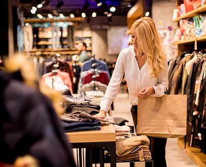 young-woman-with-shopping-bags-standing-clothing-store_52137-20576.webp