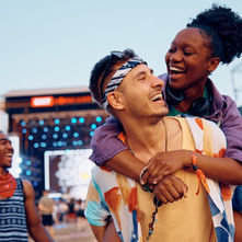 Festival crowd wearing western-inspired outfits with denim and boots