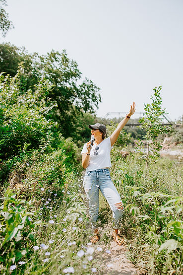 chrystal stainding on a trail with a microphone
