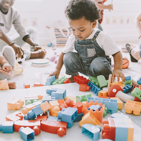 Child playing with toys in a nursery setting