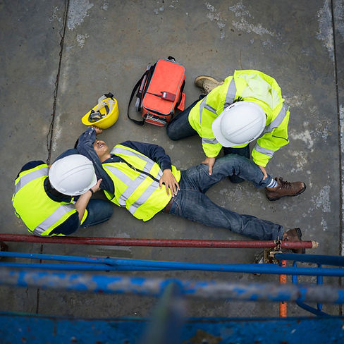 First Aider attends to a casualty with a broken leg on a construction site