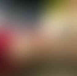 First aid being given to control heavy bleeding from a leg injury using a gloved hand