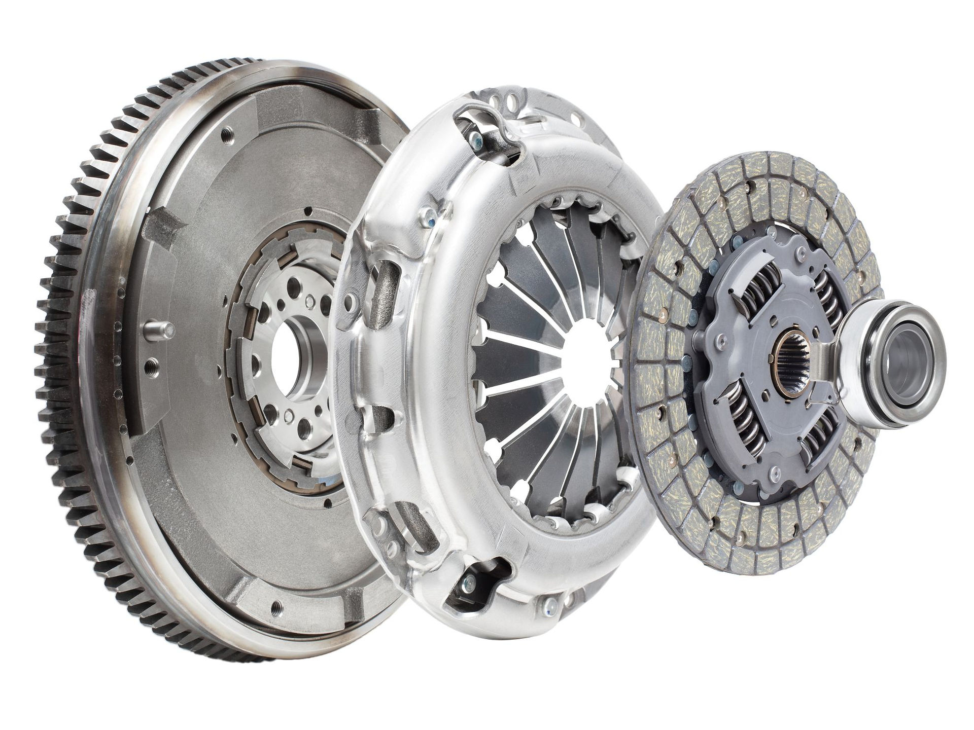 Close up exploded view of a manual car clutch assembly showing the flywheel, clutch pressure plate, friction disc, and release bearing, illustrating how engine power is transferred to the gearbox.