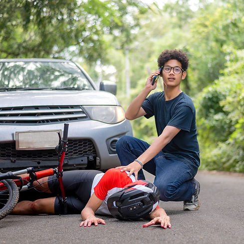 First Aider attends to a cyclist after a road traffic collision