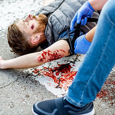 Practical first aid training scenario involving the treatment of a casualty with severe bleeding