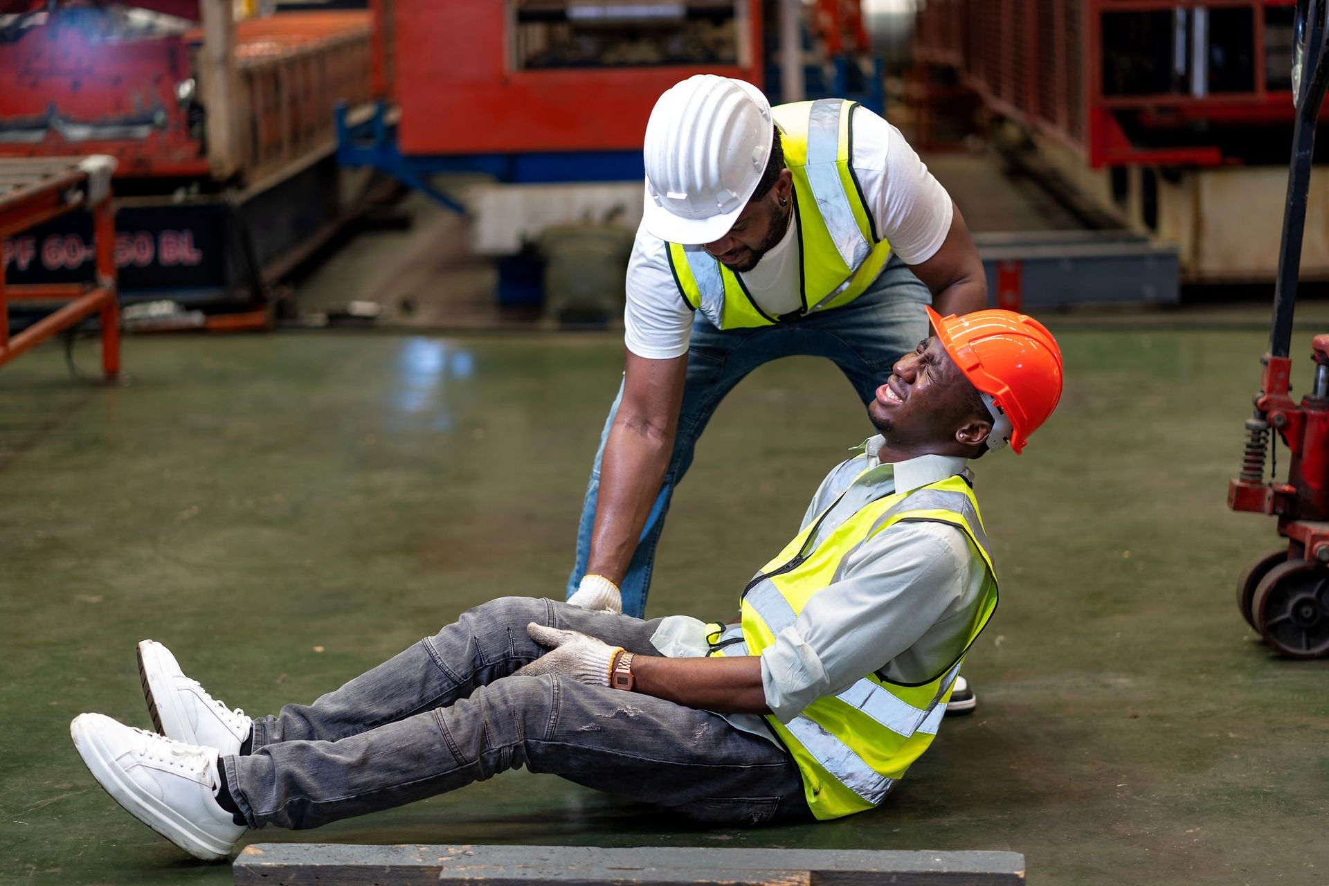 First aider assisting an injured worker following a workplace accident
