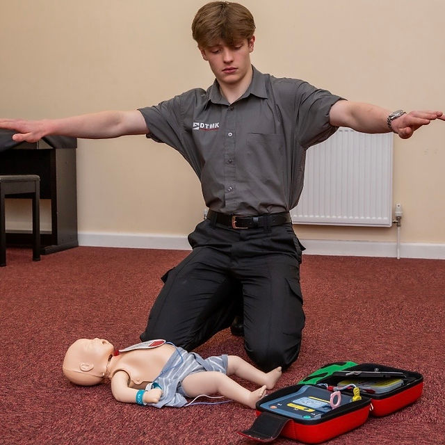 DTMK trainer demonstrating infant CPR and AED skills during a practical first aid course
