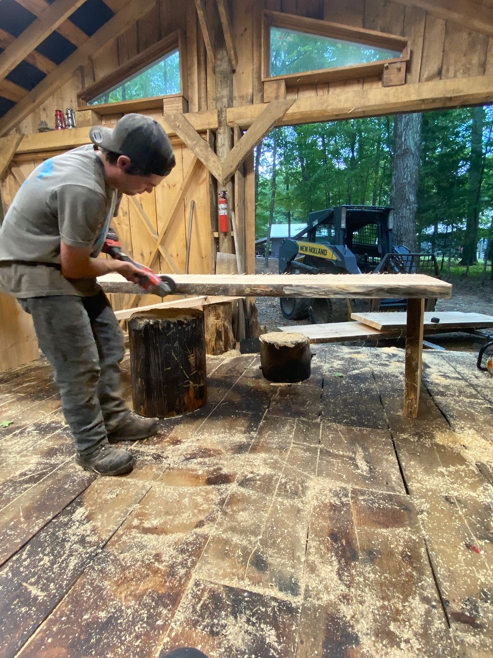 Sanding a chainsaw carved wooden table