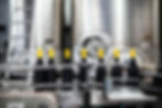 Bottling line in a modern factory filling wine bottles, illustrating automated production and global beverage trade