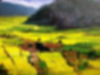 Large gray sharp rock mountains dominate over green and brown farmland blue sky with clouds