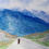 Thumbnail: person on long gray road foreground to huge mountains in background green grass both sides road