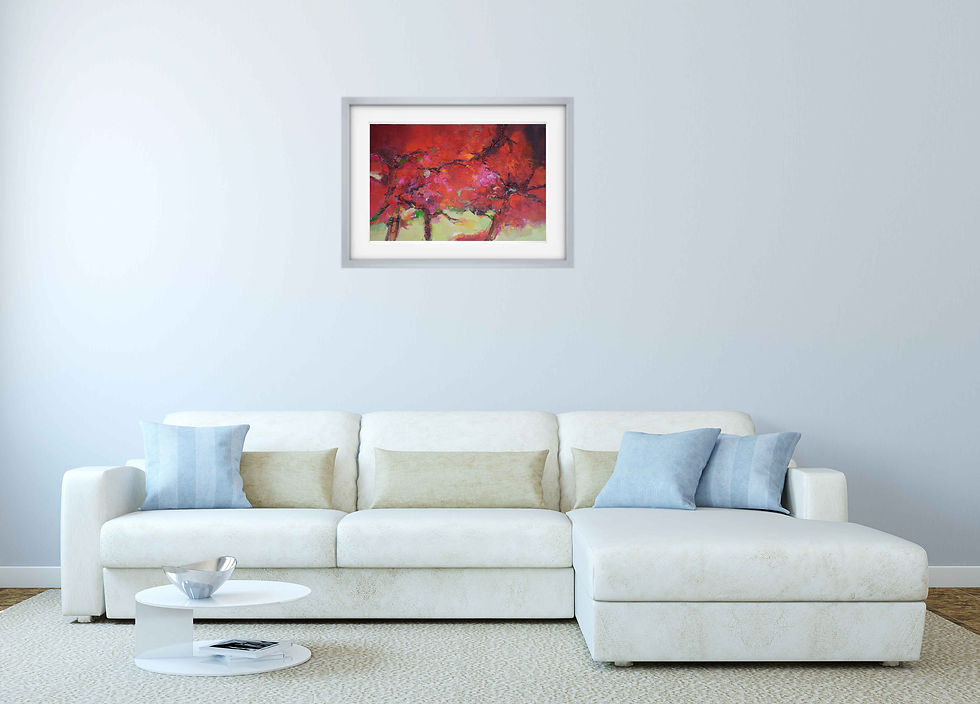 painting on light gray wall above large L shaped white sofa round coffee table in front