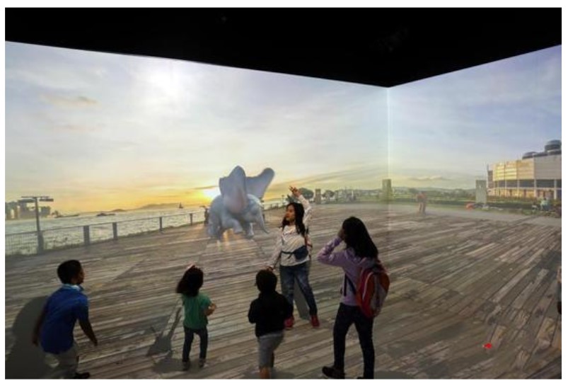 digital image of dumbo on a wall so it looks like dumbo is flying in front of a person