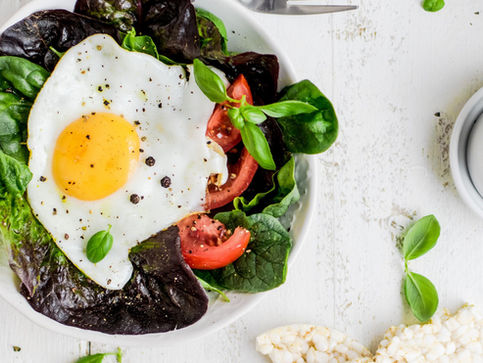 Mock fried egg on fresh dark green bed of lettuc.