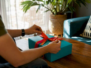Hands sealing a corporate gift box near calendar