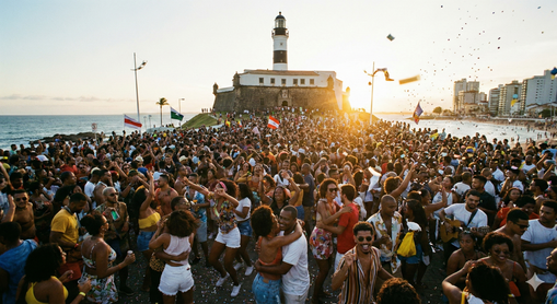 Multidão se divertindo no circuito Barra-Ondina ao pôr do sol no Carnaval de Salvador 2026, em frente ao Farol da Barra..