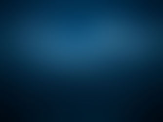 A shark fin rising out of a calm ocean at night