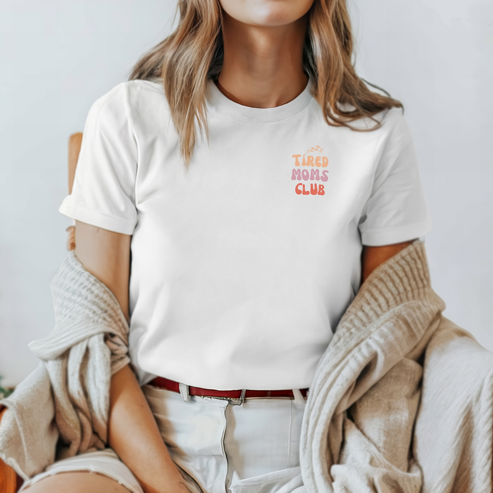 A woman wearing a white shirt that says Tired Moms Club in the right corner.
