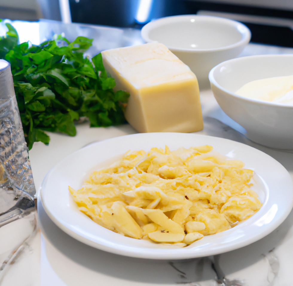 White bowl of pasta with a block of parmesan cheese in the background, a handful of fresh herms, and a bowl of heavy cream. Next to these is a metal cheese grater.