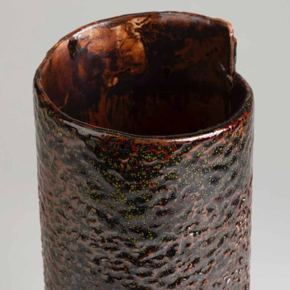 Thumbnail: 10 inch high cylinder in speckled bronze with an offset point rim