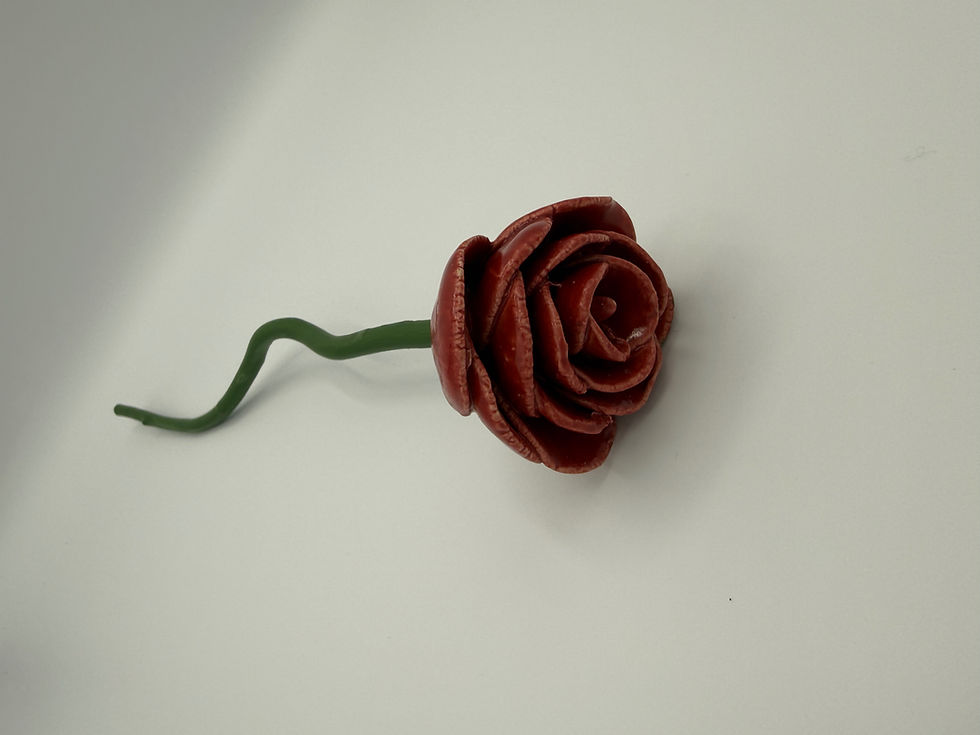 ceramic red rose with wavy wooden stem in green