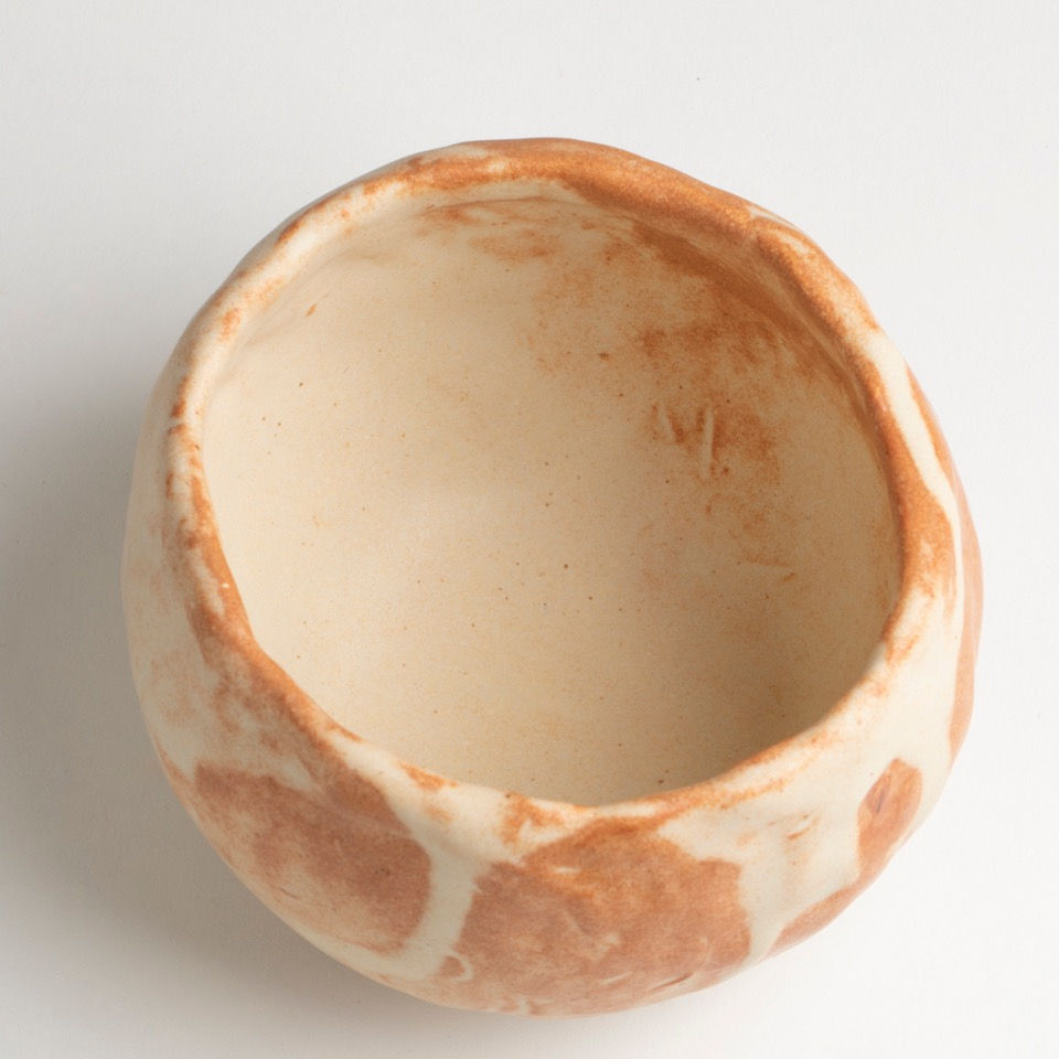 large grapefruit sized bowl in copper orange